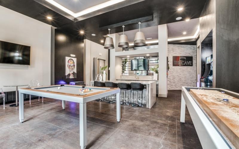 a clubroom with a pool table and chairs