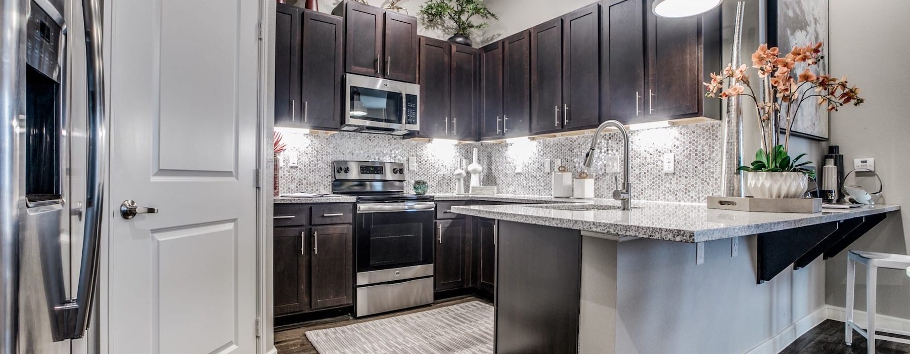 a kitchen with black cabinets