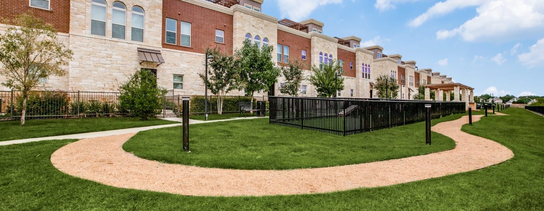 a dog park with a path around it