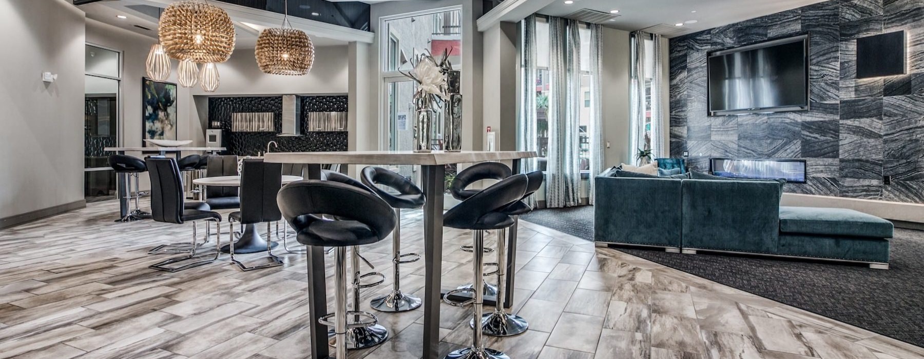 a clubroom with tables, chairs, a couch and a tv