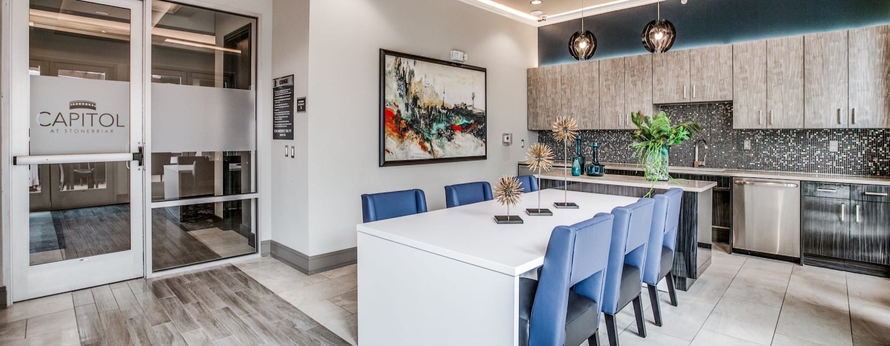 a community kitchen with a dining table and chairs