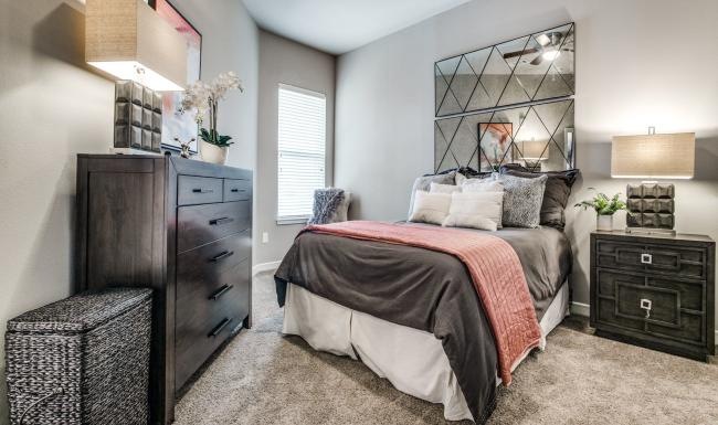 a bedroom with a bed and dresser